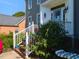 Welcome to this inviting front porch with flowers, plants and charming decor, perfect for relaxing at 1106 Purple Glory Dr, Apex, NC 27502