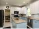 Bright kitchen with island, granite countertops, and modern appliances at 1106 Purple Glory Dr, Apex, NC 27502