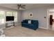 Inviting living room with a comfortable sofa, TV, and natural light at 1106 Purple Glory Dr, Apex, NC 27502