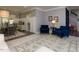 Bright living room featuring marble floors, wainscoting, and lovely floral wallpaper accents, adding to the home's charm at 1106 Purple Glory Dr, Apex, NC 27502