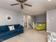 Spacious living room with a blue sofa and staircase to another level at 1106 Purple Glory Dr, Apex, NC 27502