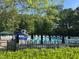 Community pool area featuring lounge chairs, umbrellas, slide, and lush greenery at 1106 Purple Glory Dr, Apex, NC 27502
