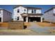 New construction home with Tyvek wrap, showing the initial stages of the building process and attached garage at 1112 Landen Creek Ln, Zebulon, NC 27597