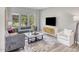 Comfortable living room featuring modern decor, a large TV, and a view to the outdoors at 1112 Landen Creek Ln, Zebulon, NC 27597