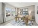 A stylish office featuring natural light, modern decor, a work desk, and a blue accent rug at 1112 Landen Creek Ln, Zebulon, NC 27597