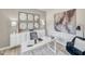 Modern home office with white desk, accent chair, decorative mirror, and stylish decor at 1112 Landen Creek Ln, Zebulon, NC 27597