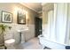Classic bathroom featuring a clawfoot tub, pedestal sink, and beadboard paneling at 117 Hillcrest Rd, Raleigh, NC 27605