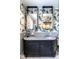 Elegant bathroom with double vanity, marble countertop, and unique tropical wallpaper at 117 Hillcrest Rd, Raleigh, NC 27605