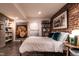 Cozy bedroom featuring brick accent wall, posters, and comfortable decor at 117 Hillcrest Rd, Raleigh, NC 27605