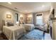 Cozy bedroom featuring two twin beds, a fireplace, and natural light through the window at 117 Hillcrest Rd, Raleigh, NC 27605