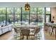 Modern dining room featuring a round table, statement chandelier, and a large picture window at 117 Hillcrest Rd, Raleigh, NC 27605