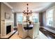 Elegant dining room with a fireplace, chandelier lighting and modern furnishings at 117 Hillcrest Rd, Raleigh, NC 27605