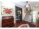 Grand foyer featuring hardwood floors, elegant staircase, and classic decor with eye-catching artwork at 117 Hillcrest Rd, Raleigh, NC 27605
