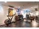 Bright workout room with weights, bench, exercise bike, and mirrored wall at 117 Hillcrest Rd, Raleigh, NC 27605