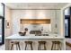Modern kitchen features a large island with seating, sleek white cabinets, wood accents, and stainless steel appliances at 117 Hillcrest Rd, Raleigh, NC 27605