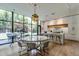 Modern kitchen featuring sleek white cabinetry, a marble countertop and oversized windows at 117 Hillcrest Rd, Raleigh, NC 27605