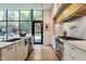 Bright kitchen with a large island, stainless steel appliances, and a view of the backyard through large windows at 117 Hillcrest Rd, Raleigh, NC 27605