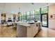 Bright open kitchen with large windows overlooking the backyard, stainless steel appliances, and modern lighting at 117 Hillcrest Rd, Raleigh, NC 27605
