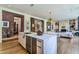 Modern kitchen features a large island, stainless steel appliances, and access to other living areas at 117 Hillcrest Rd, Raleigh, NC 27605