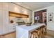 Modern kitchen features a large waterfall island with seating, sleek white cabinets, and stainless steel appliances at 117 Hillcrest Rd, Raleigh, NC 27605