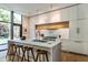 Chic kitchen with a marble island, stainless steel appliances, and wood counter stools at 117 Hillcrest Rd, Raleigh, NC 27605