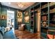 Stylish library with built-in shelving, classic artwork, and a comfortable reading chair at 117 Hillcrest Rd, Raleigh, NC 27605