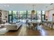 Bright, open-concept living room with large windows offering views of the landscaped backyard and modern furniture at 117 Hillcrest Rd, Raleigh, NC 27605