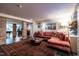 Beautiful living room featuring a red velvet couch, artwork, and exposed brick at 117 Hillcrest Rd, Raleigh, NC 27605