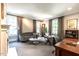 Spacious living room with multiple windows, a curved sofa, and a classic, timeless feel at 117 Hillcrest Rd, Raleigh, NC 27605