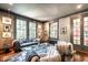 Stylish living room with large windows, comfortable seating, and chic decor in neutral tones at 117 Hillcrest Rd, Raleigh, NC 27605