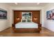 Stylish main bedroom features wood-paneled accent wall, platform bed, and modern decor at 117 Hillcrest Rd, Raleigh, NC 27605