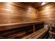Interior view of sauna with wooden benches, slatted walls, and overhead lighting at 117 Hillcrest Rd, Raleigh, NC 27605