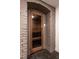 Intimate sauna room featuring a glass front door, wooden seating and benches at 117 Hillcrest Rd, Raleigh, NC 27605
