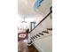Elegant entryway with staircase featuring white banisters, wood steps, and decorative rug at 117 Hillcrest Rd, Raleigh, NC 27605