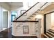 Elegant staircase with wood railings, white spindles, and artwork on the walls at 117 Hillcrest Rd, Raleigh, NC 27605