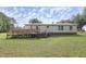 Expansive backyard with wheelchair ramp and outdoor access from the back of the house at 1201 Red Sunset Pl, Siler City, NC 27344