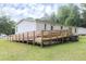 Spacious backyard features a large ramp, ideal for outdoor accessibility and gatherings at 1201 Red Sunset Pl, Siler City, NC 27344