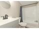 Stylish bathroom features a gray vanity with a tub and shower at 1201 Red Sunset Pl, Siler City, NC 27344