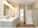 Bright bathroom features a double vanity, modern lighting, and a walk-in shower at 1201 Red Sunset Pl, Siler City, NC 27344