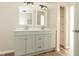 Bright bathroom features a double vanity with modern lighting and cabinetry at 1201 Red Sunset Pl, Siler City, NC 27344