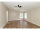 Spacious bedroom with a ceiling fan and large windows, offering a bright and airy feel at 1201 Red Sunset Pl, Siler City, NC 27344