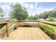 Exterior wooden deck with a wood railing overlooks the front community at 1201 Red Sunset Pl, Siler City, NC 27344