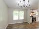 Bright dining area with natural light, featuring hardwood floors and a stylish chandelier at 1201 Red Sunset Pl, Siler City, NC 27344
