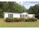 Charming single-story home with manicured landscaping and a cozy front deck at 1201 Red Sunset Pl, Siler City, NC 27344