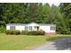 Welcoming single-story home with well-maintained lawn and a convenient access ramp at 1201 Red Sunset Pl, Siler City, NC 27344