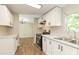 Clean kitchen with white cabinets, stainless steel appliances, connecting seamlessly to a bright dining area at 1201 Red Sunset Pl, Siler City, NC 27344