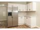 Modern kitchen with stainless steel refrigerator, white cabinets, and durable countertops for an easy cleanup at 1201 Red Sunset Pl, Siler City, NC 27344
