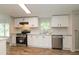 Well-lit kitchen featuring white cabinets, stainless steel appliances, and durable countertops for a modern feel at 1201 Red Sunset Pl, Siler City, NC 27344