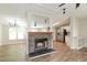 Inviting living area featuring a stone fireplace, seamlessly connecting to the kitchen at 1201 Red Sunset Pl, Siler City, NC 27344