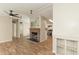 Inviting living room featuring a cozy fireplace, ceiling fan, and seamlessly connecting to the kitchen area at 1201 Red Sunset Pl, Siler City, NC 27344